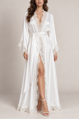 Model wearing the V.I.P.A Milady off-white satin kimono dress with lace edges, bell sleeves and waist tie, bridal look