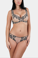 Model wearing the V.I.P.A Daniella balconette bra for fuller busts in nude with black lace, with matching panty