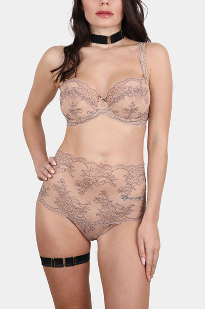 Model wearing the V.I.P.A Tattoo Nude underwired soft cup lace bra in nude with the high-waisted lace panty