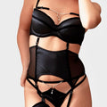 Model wearing the V.I.P.A Isadora black satin suspender belt with bra and stockings