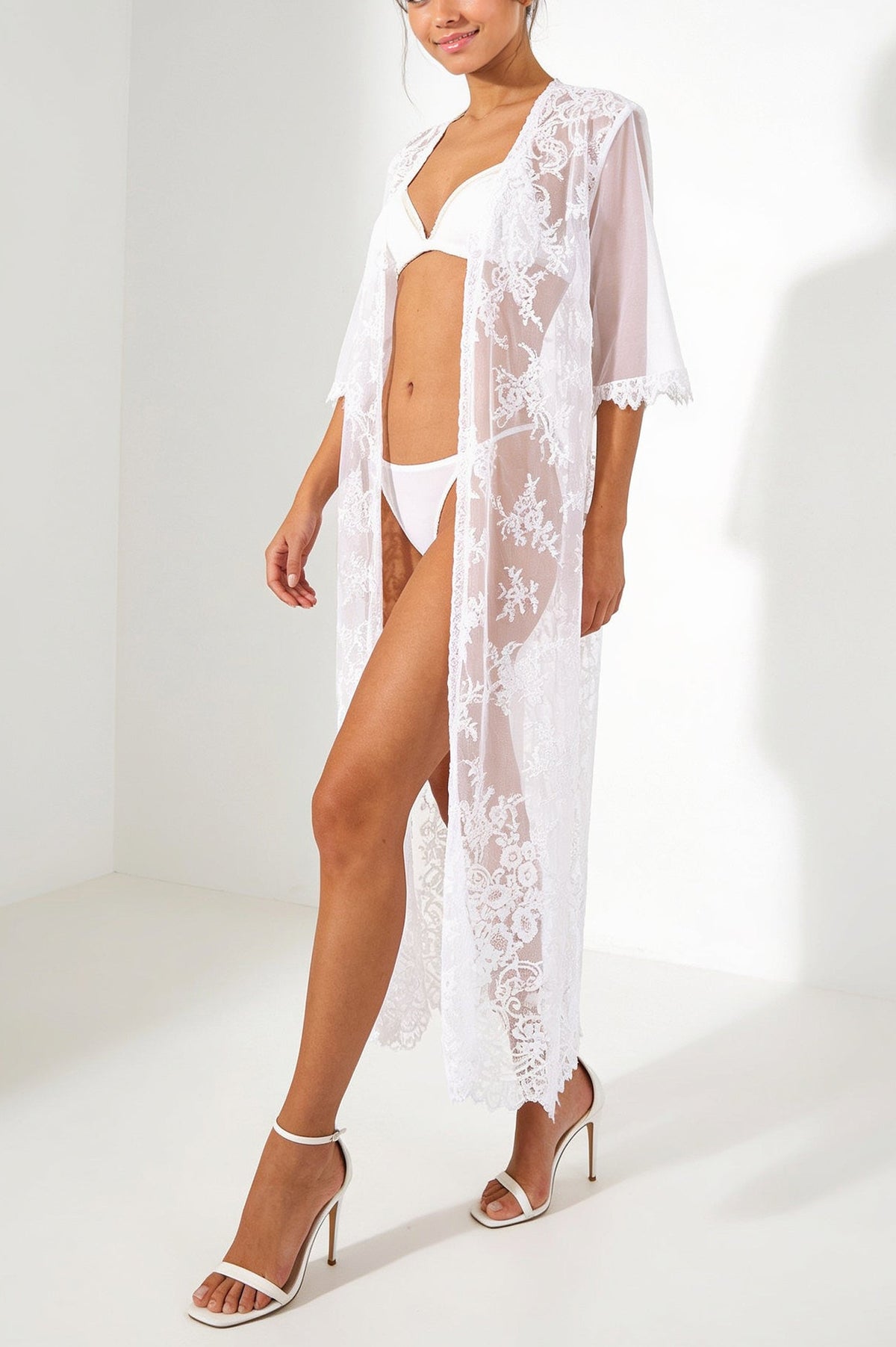 Model wearing the V.I.P.A Jacqueline long white lace kimono robe over white lingerie, bridal look